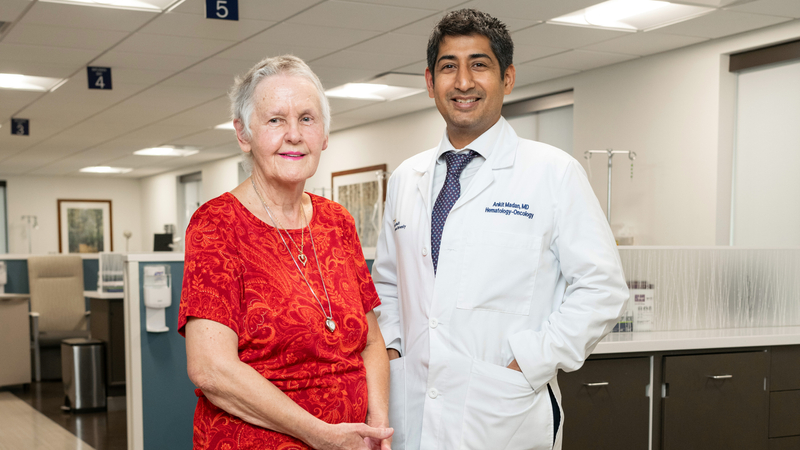 Donna Moore stands with Dr. Ankit Madan after undergoing successful treatment for breast cancer at MedStar Health.