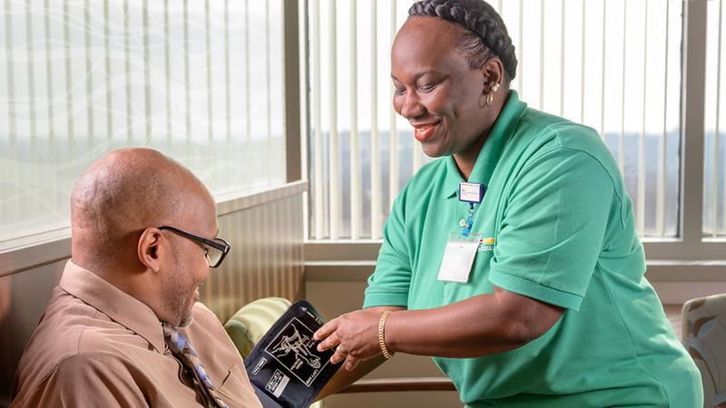 A nurse takes a blood pressure reading for a man at the Center for Successful Aging at MedStar Health.