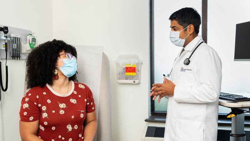Dr Ankit Madan talks with a female patient during an office visit at MedStar Health.