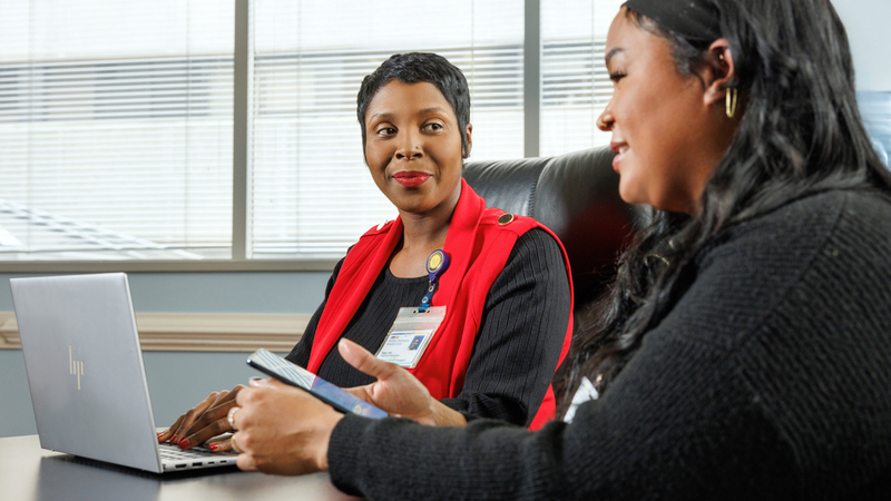 Tiara Hill, treatment navigator, talks with a patient at MedStar Health.