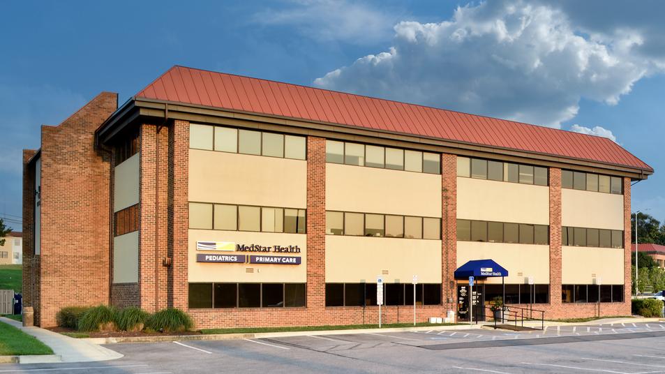 A red brick and glass office building is home to MedStar Health Primary Care at Wilkens Avenue in Baltimore, Maryland.