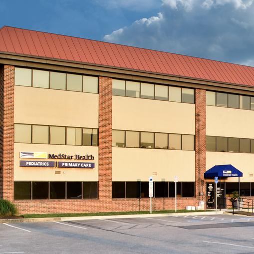 A red brick and glass office building is home to MedStar Health Primary Care at Wilkens Avenue in Baltimore, Maryland.