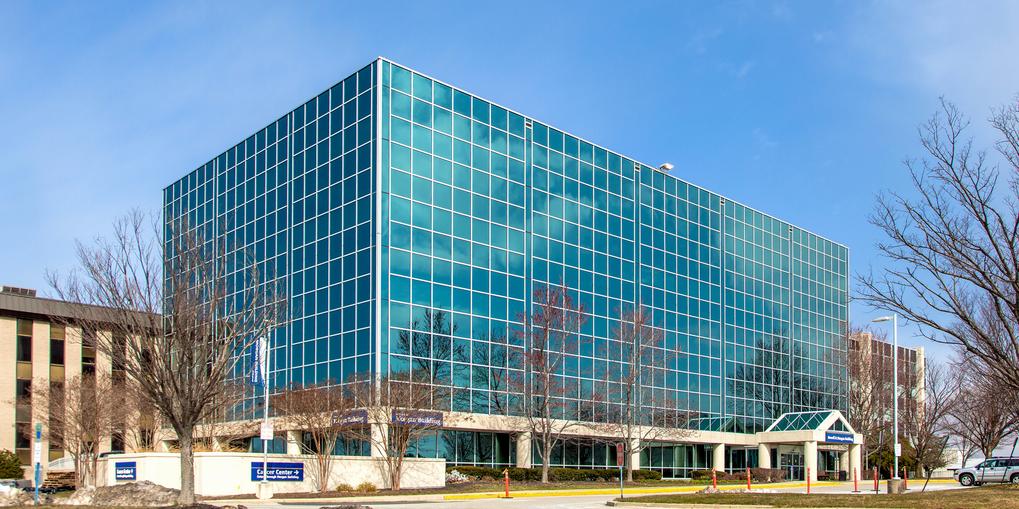 The Russell Morgan building on the campus of MedStar Health Good Samaritan Hospital is a modern blue-green glass building.