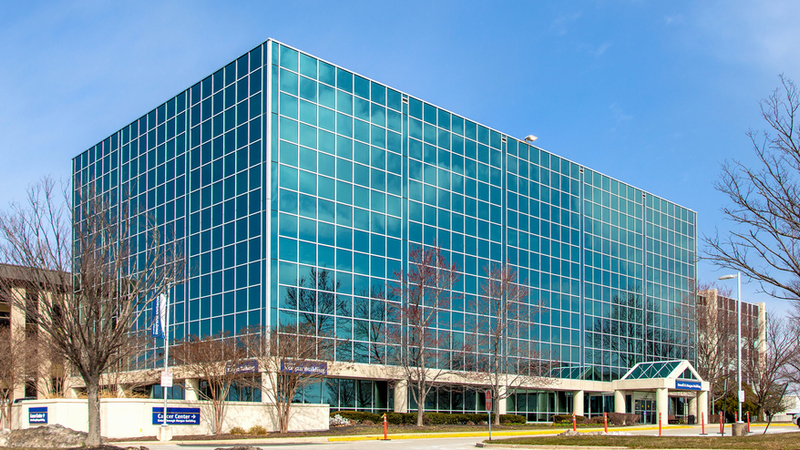 The Russell Morgan building on the campus of MedStar Health Good Samaritan Hospital is a modern blue-green glass building.