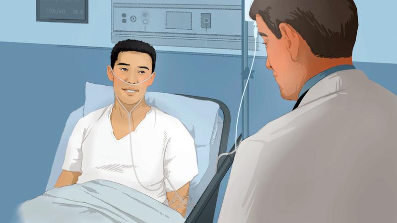 A doctor talks to a patient in a hospital bed.