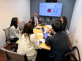 Dr Ethan Booker discusses telehealth technology at MedStar Health with a group of medical professionals from South Korea.