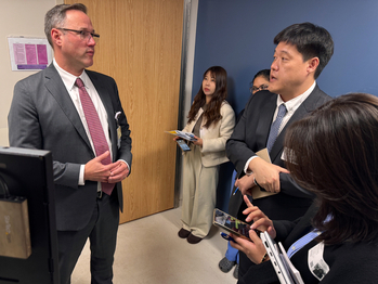 Dr Ethan Booker discusses telehealth technology at MedStar Health with a group of medical professionals from South Korea.