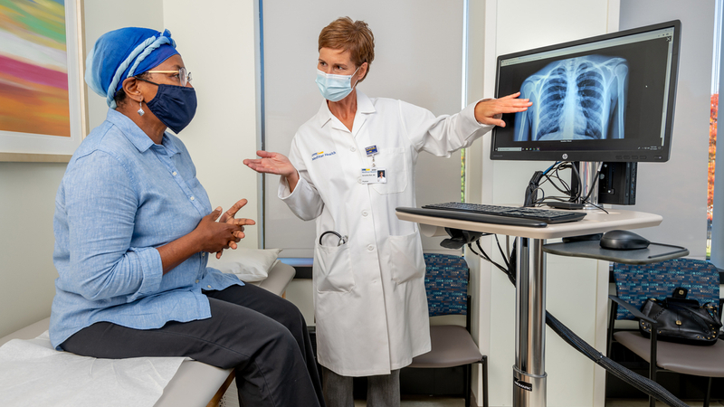 A female doctor consults with an african american female patient in a clinical setting.