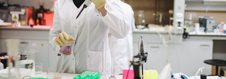 Close up of a scientist working with liquids in a laboratory.