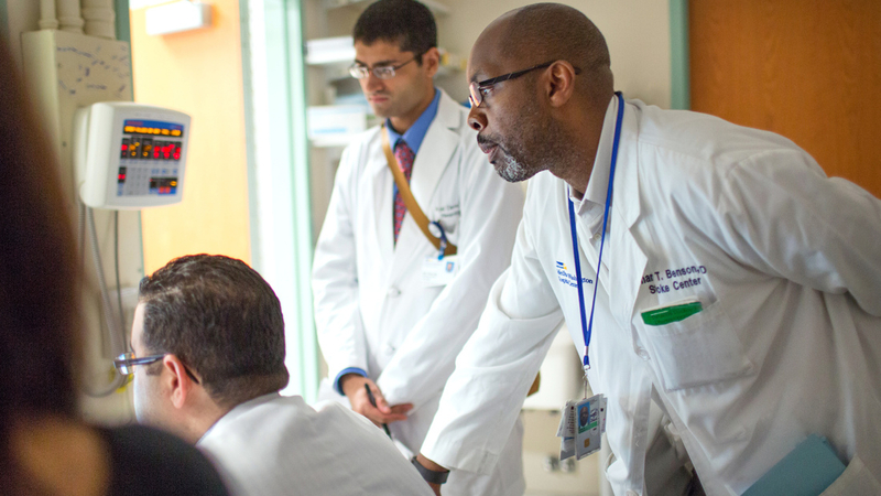 Doctors from the MedStar Health stroke team check in on a patient during hospital rounds.