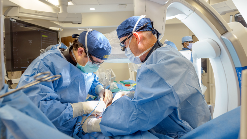 Doctors Jeffrey Cohen and Lowell Satler perform surgery in an operating room at MedStar Health.
