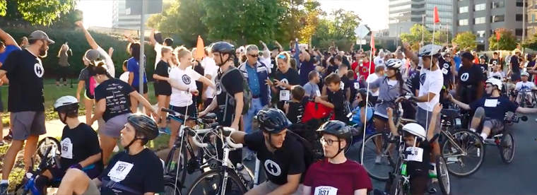 Participants gather at the starting line for a walk, run, wheelchair race event.