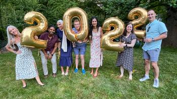 Graduates from the Pulmonary Critical Care Medicine Fellowship hold balloons and stand outside to pose for a photo.