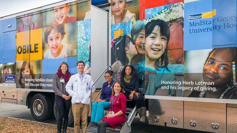 Staff from MedStar Health's mobile clinic poses for a group photo in front of the truck.