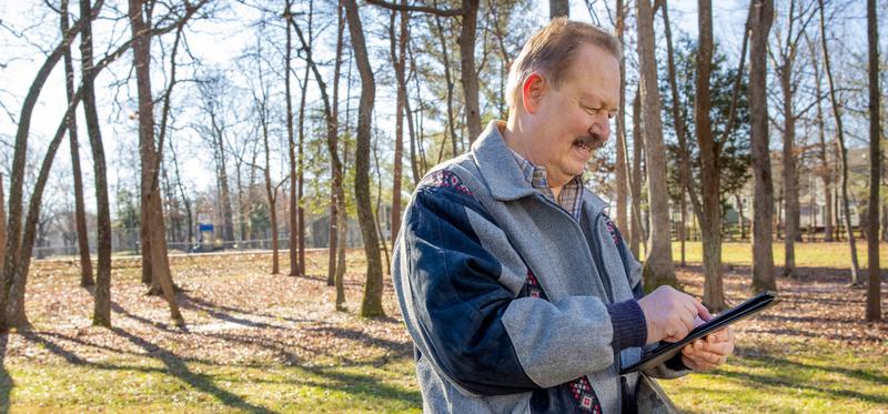 Michael Leggett, a MedStar Health patient, uses a tablet to check into an app that helps him keep track of his daily vital signs and symptoms.