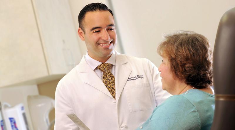 Dr. Gabriel Del Corral talks with a patient in a clinical setting.