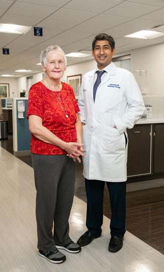 Donna Moore stands with Dr. Ankit Madan after undergoing successful treatment for breast cancer at MedStar Health.