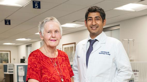 Donna Moore stands with Dr. Ankit Madan after undergoing successful treatment for breast cancer at MedStar Health.