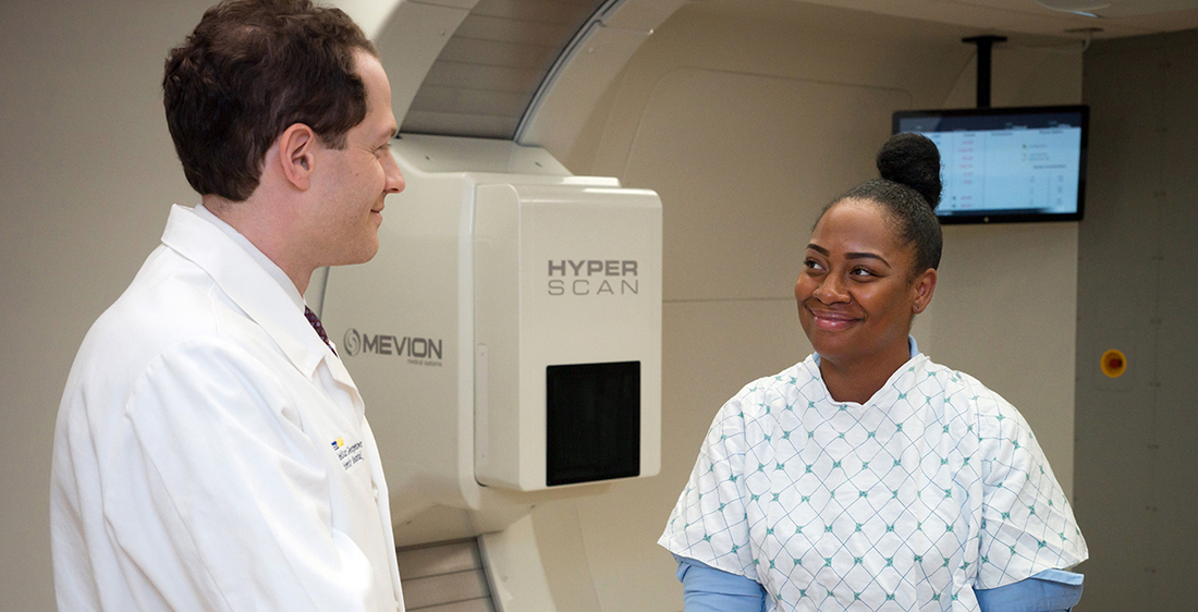 Dr Keith Unger consults with a female patient in the Cyberknife center.