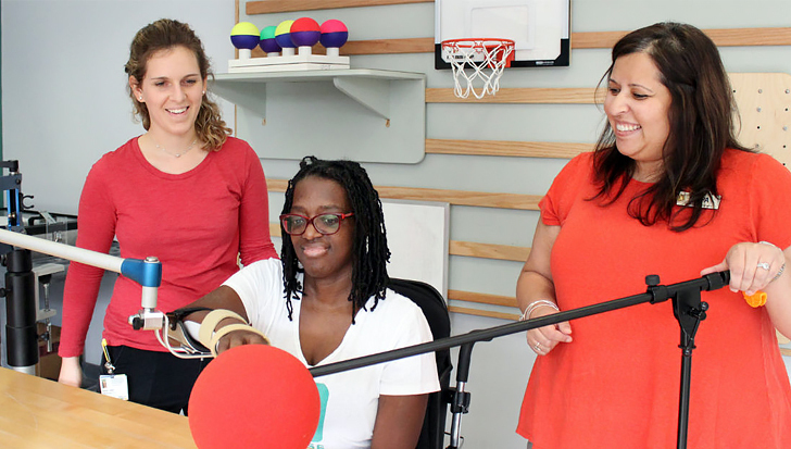 Therapists work with a patient in an occupational therapy rehabilitation gym at MedStar Health.