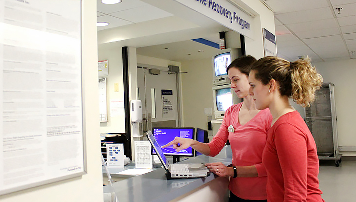 Therapists work with a patient in an occupational therapy rehabilitation gym at MedStar Health.