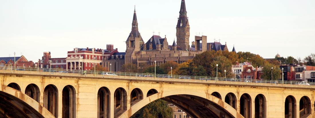 The Francis Scott Key Memorial Bridge is pictured in front of the historic stone buildings on the campus of Georgetown University, Washington DC.