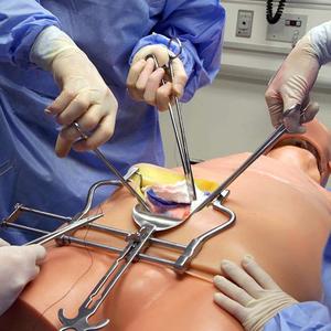 Close up photo of physicians learning surgical techniques on a simulation mannequin at MedStar Health.