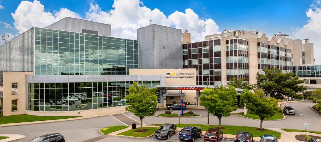 Aerial view of MedStar Good Samaritan Hospital - a modern blue-green glass and concrete building in Baltimore, Maryland.