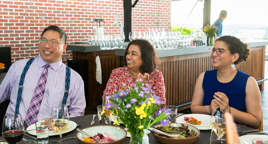 Internal medicine residency faculty members enjoy a casual conversation at an outdoor restaurant..