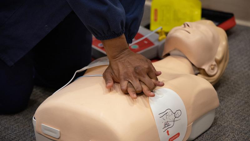 close up photo of hands performing CPR on a simulation mannequin