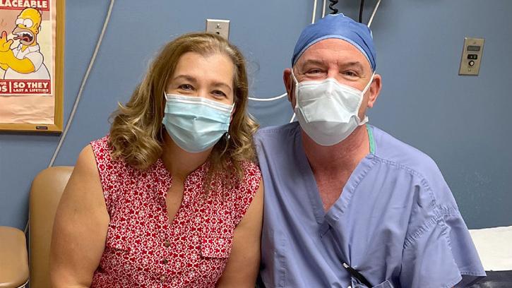 Dr Paul Cooper poses for a photo with a patient who underwent successful orthopedic surgery and received an ankle implant.