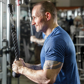 Ryan Jander lifts weights in a gym. Jander suffered from elbow pain before seeking treatment for from MedStar Orthopedics.