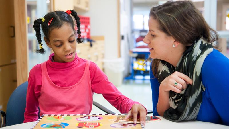 A physical therapist works with a child pediatric patient to regain strength & mobility to build the confidence needed to thrive.