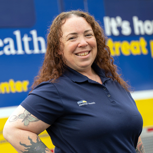 The MedStar Health mobile healthcare team poses for a photo in front of the mobile healthcare center truck.