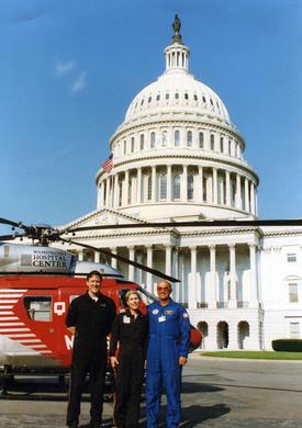 Historic photo of the MedStar transit group and the MedStar Washington Hospital Center helicopter in front of the US Capitol building.