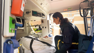 The MedStar Health helicopter crew unloads a patient on a hospital helipad.