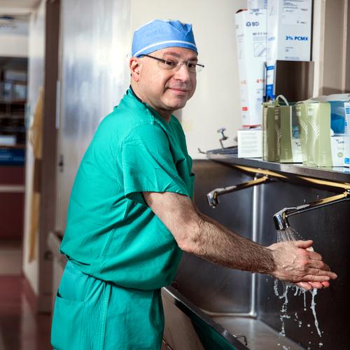 Portrait of Dr. Jeffrey Ferris washing his hands at a scrub sink outside of an operating room at MedStar Franklin Square Medical Center.