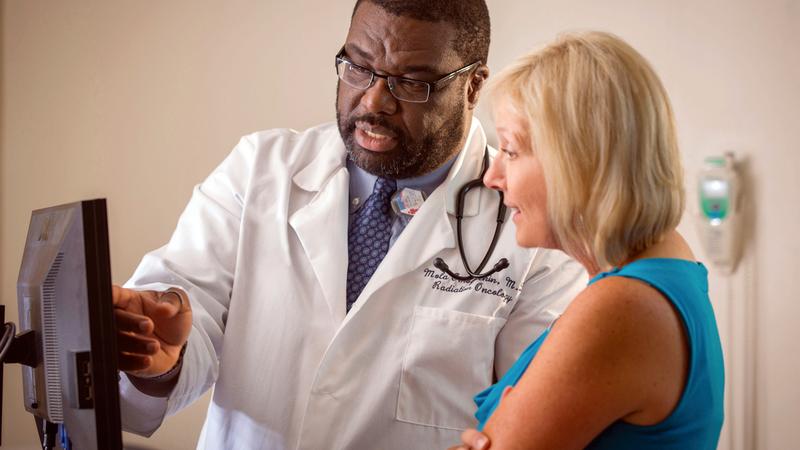 Dr Adedamola Obogbehin consults with a female patient.