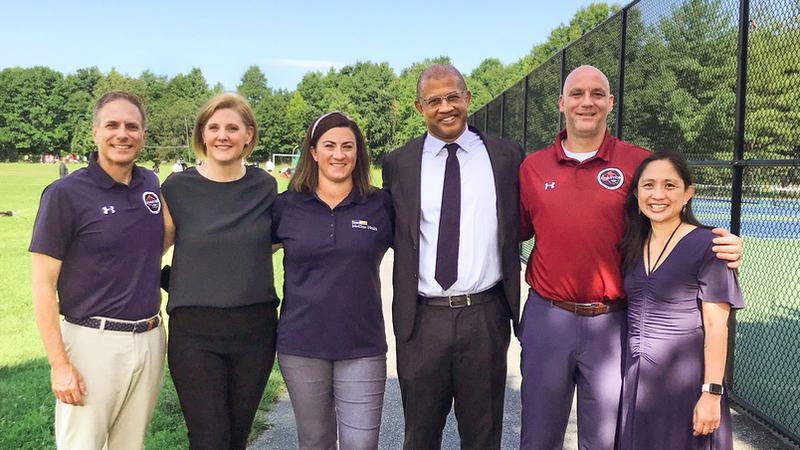 Healthcare professionals from the sports medicine team at MedStar Heath pose for a group photo outdoors.