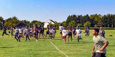 Youth football players from Montgomery County, Maryland, run on their practice field.