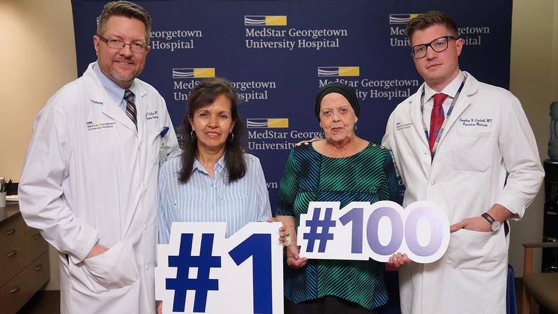Dr Brian Collins poses for a photo with the 1st and 100th patients treated with proton therapy at MedStar Georgetown University Hospital.