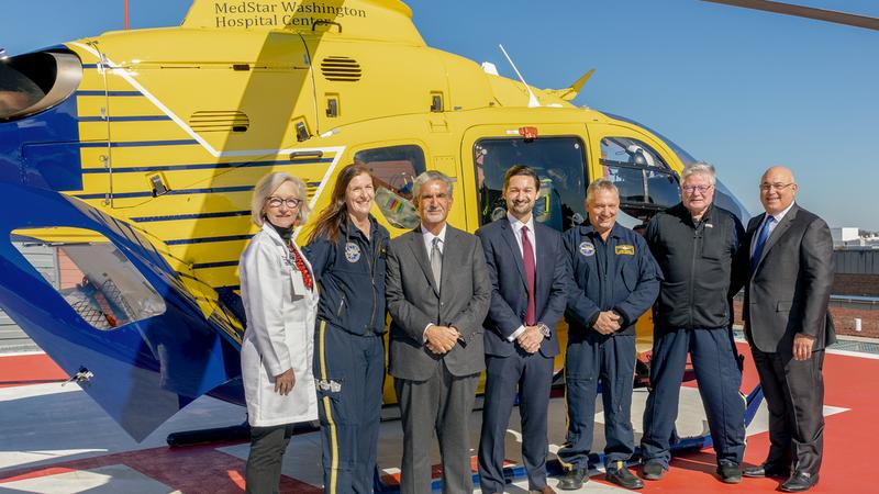 Group photo with Ted Leonsis and officials from MedStar Georgetown University Hospital pose for a group photo in front of the MedStar Health helicopter on the helipad.