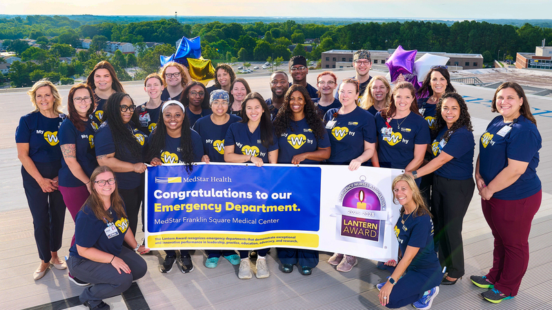 A group of nurses pose for a group photo on the rooftop helipad at MedStar Franklin Square Medical Center.