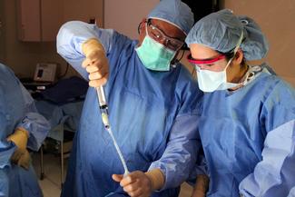 Dr. Maen Farha and his team perform surgery in an operating room at a MedStar Health hospital. 