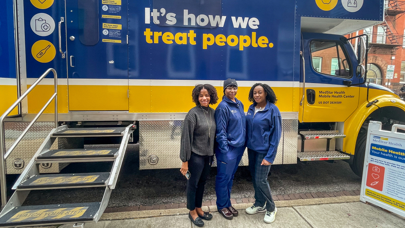 MedStar Health staff stand in front of the mobile health clinic truck in Baltimore.