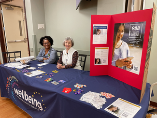 Associates from MedStar Health sit at a table displaying information about suicide prevention.