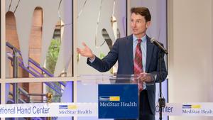Dr. James Higgins speaks at an event to mark MedStar Health's unveiling of the Curtis National Hand Center expansion project.