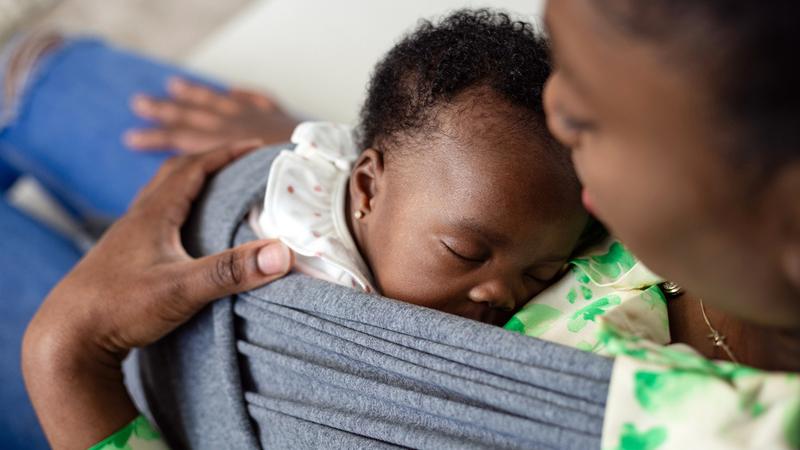 A mother holds her newborn baby.