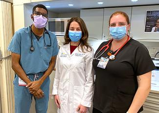 Dr. Janine Rethy stands with 2 medical assistants in the MedStar Health Mobile Health truck.