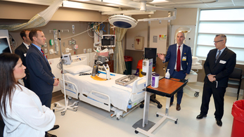 Dr. Shane Kappler welcomes guests from HHS to tour the biocontainment unit at MedStar Washington Hospital Center.